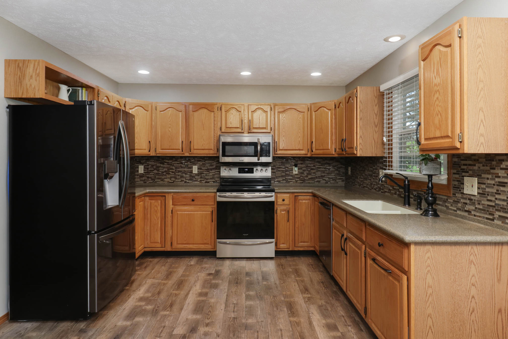 3203 Eagle Crest Road Bloomington, IL 61704 - Photo 9 of 52 a kitchen with stainless steel appliances granite countertop a refrigerator a stove top oven a sink and dishwasher