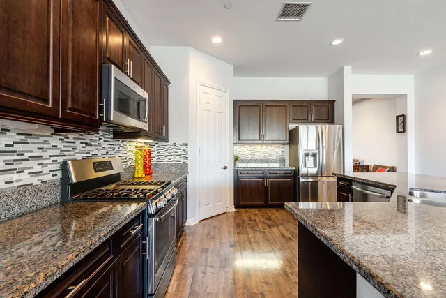 a living room with furniture kitchen view and a window