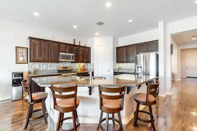 a living room with furniture kitchen and a table
