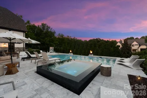 a view of a patio with couches table and chairs and potted plants