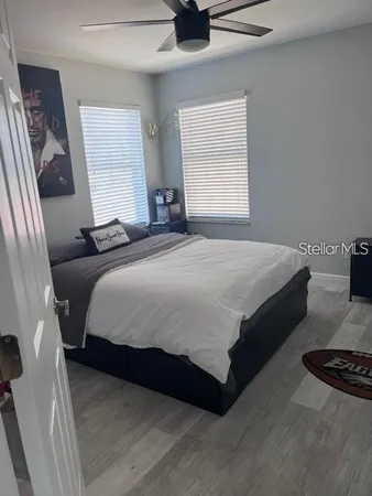 a bedroom with a bed and a chandelier