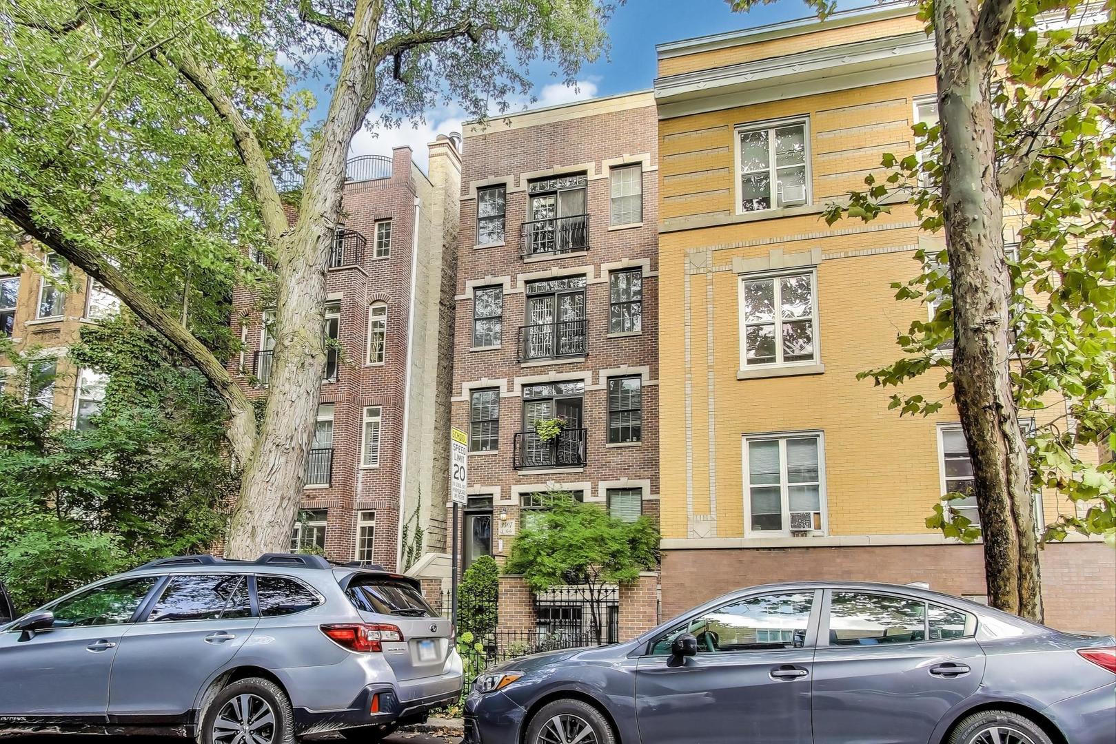 a front view of a residential apartment building with a yard