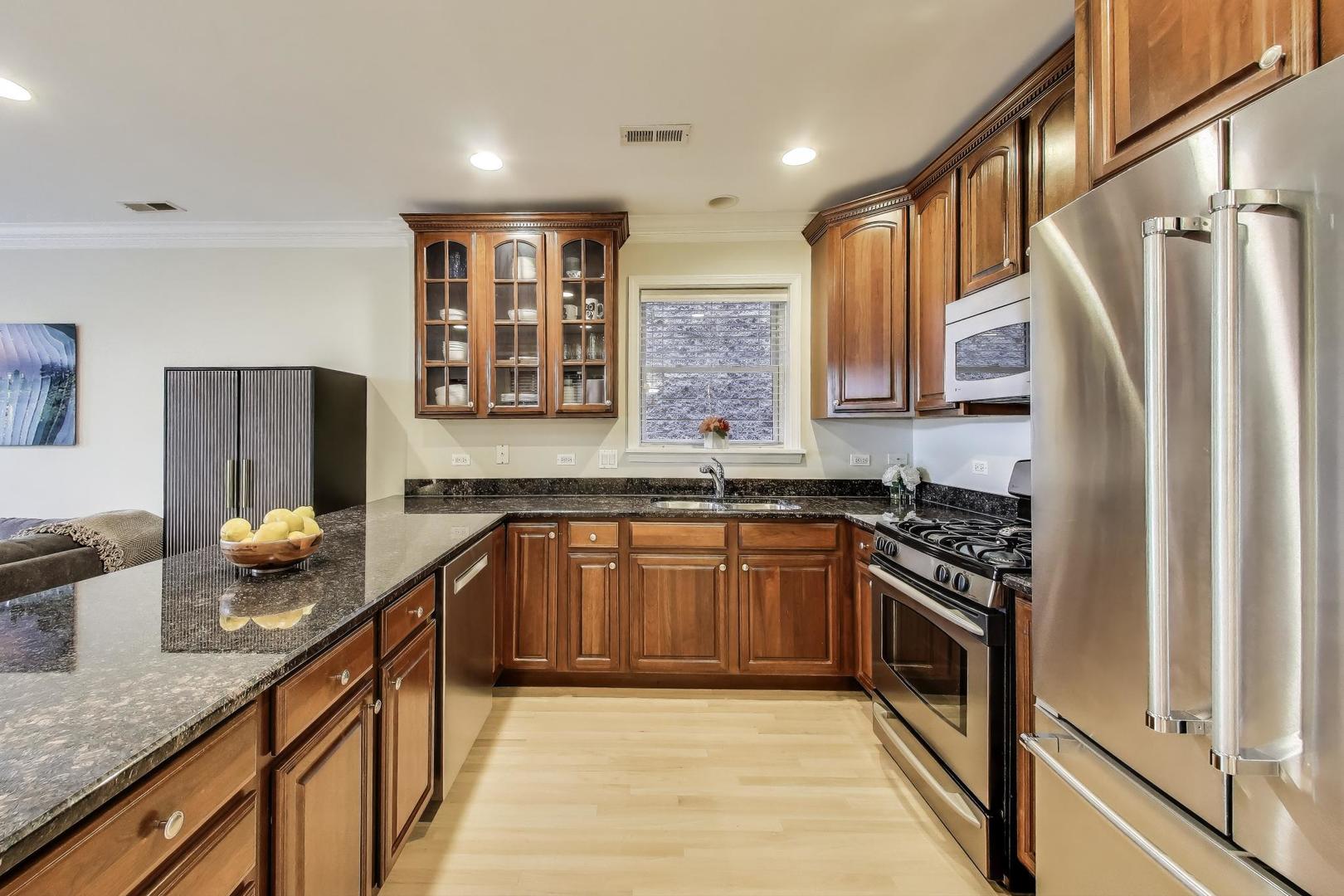 3507 North Reta Avenue, Unit 3 Chicago, IL 60657 - Photo 11 of 24 a kitchen with stainless steel appliances granite countertop a stove a sink and a refrigerator