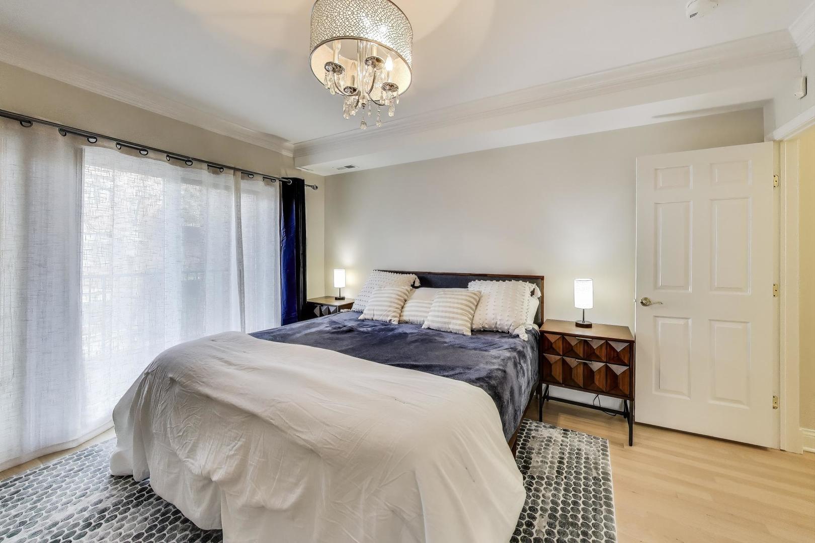 3507 North Reta Avenue, Unit 3 Chicago, IL 60657 - Photo 14 of 24 a bedroom with a bed and a chandelier