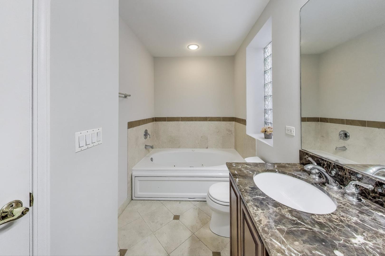 3507 North Reta Avenue, Unit 3 Chicago, IL 60657 - Photo 18 of 24 a bathroom with a sink and a mirror