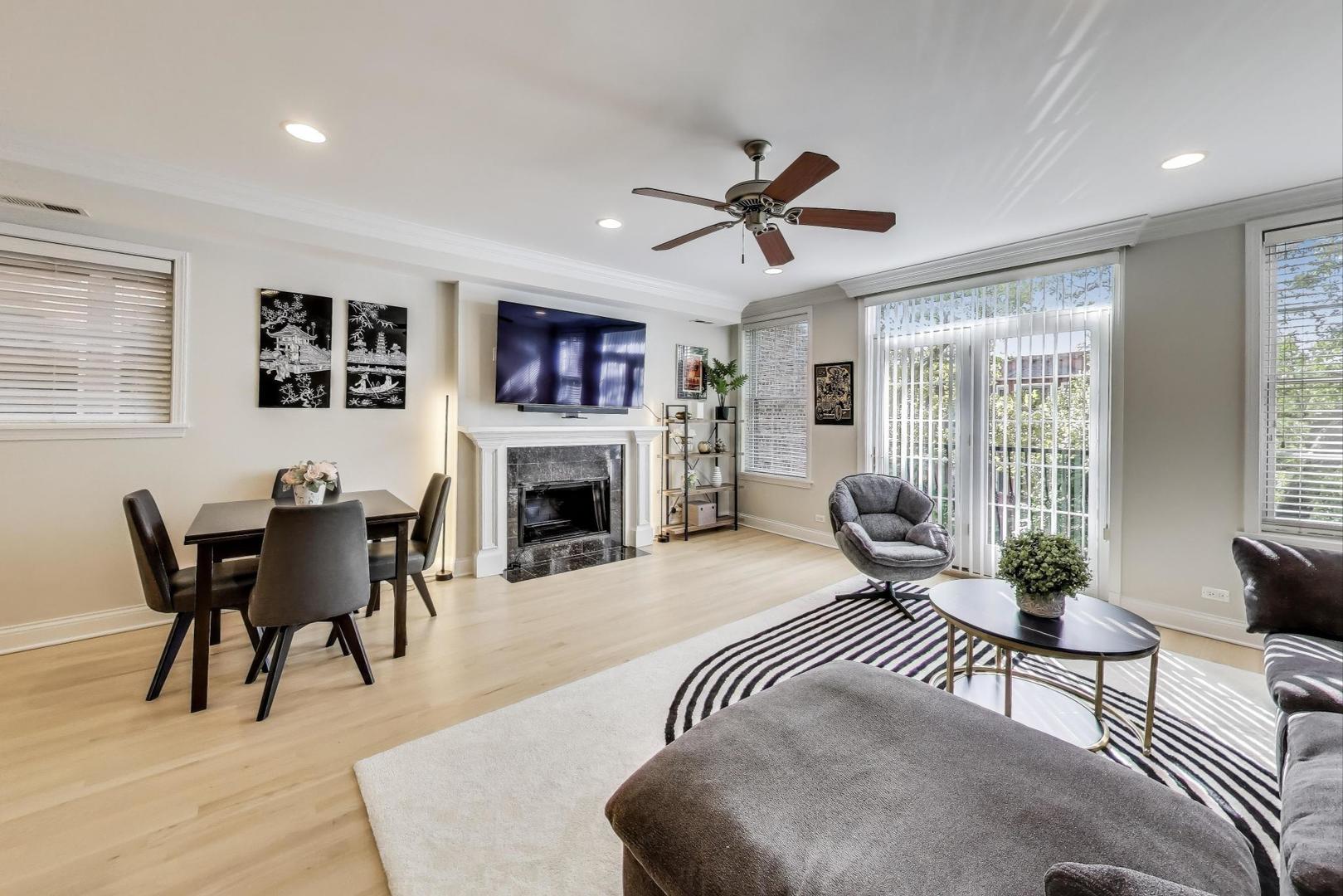 3507 North Reta Avenue, Unit 3 Chicago, IL 60657 - Photo 6 of 24 a living room with furniture a fireplace and a table