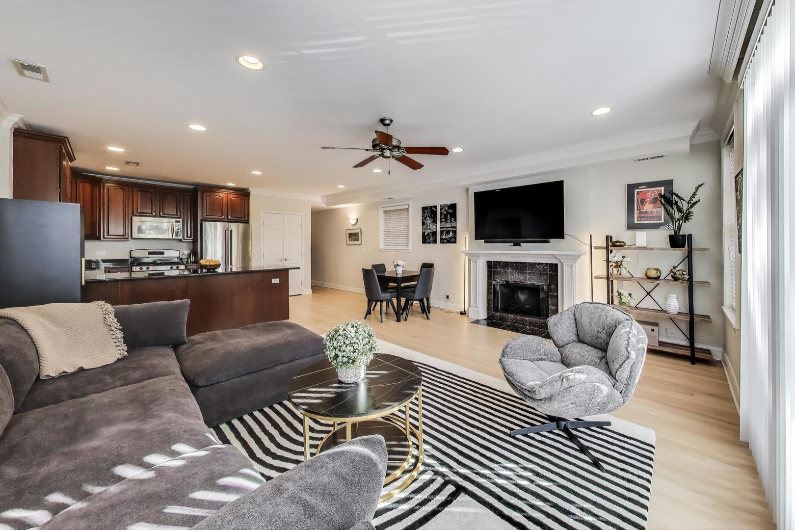 3507 North Reta Avenue, Unit 3 Chicago, IL 60657 - Photo 7 of 24 a living room with furniture a fireplace and a flat screen tv