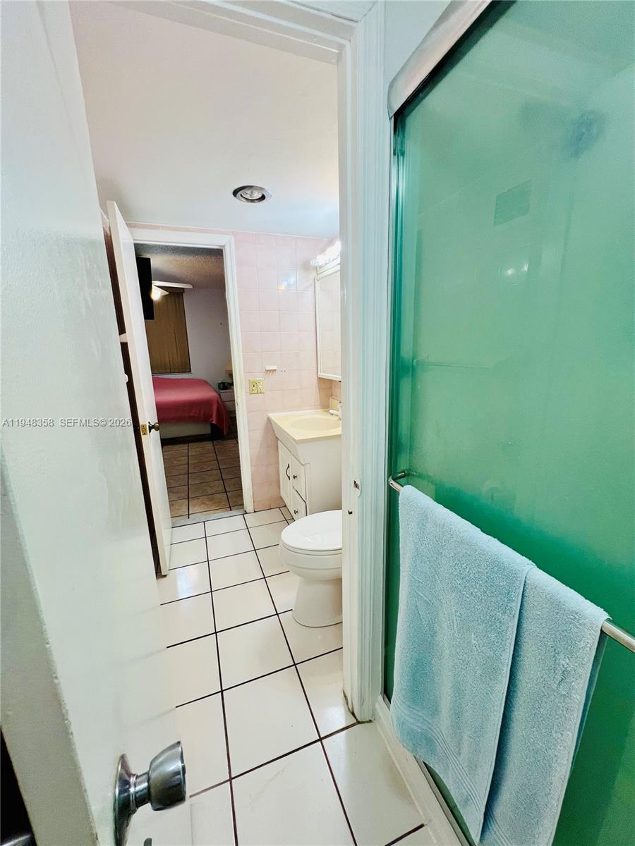 1331 Lincoln Road, Unit 701 Miami Beach, FL 33139 - Photo 12 of 18 a bathroom with a toilet and a mirror