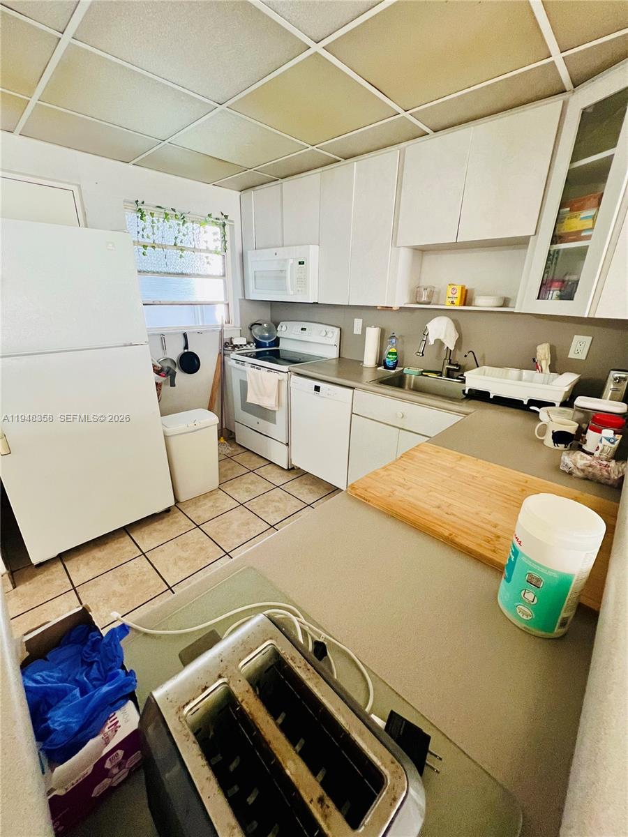 1331 Lincoln Road, Unit 701 Miami Beach, FL 33139 - Photo 5 of 18 a kitchen with a sink appliances and cabinets