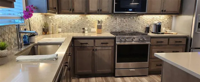 a kitchen with a stove and a refrigerator