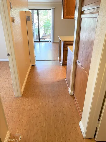 a view of a hallway with furniture and a window