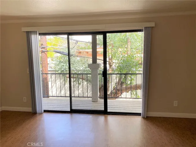 a view of a room with wooden floor and city view