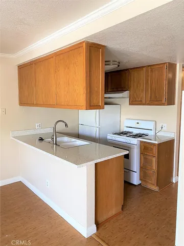 a kitchen that has a sink and a stove in it