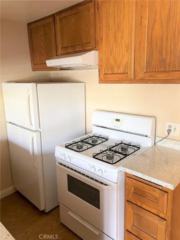 a kitchen with granite countertop cabinets and steel stainless steel appliances