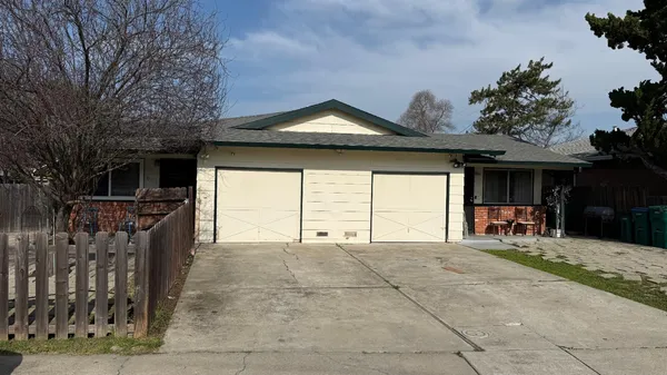 a view of a house with a backyard and a porch