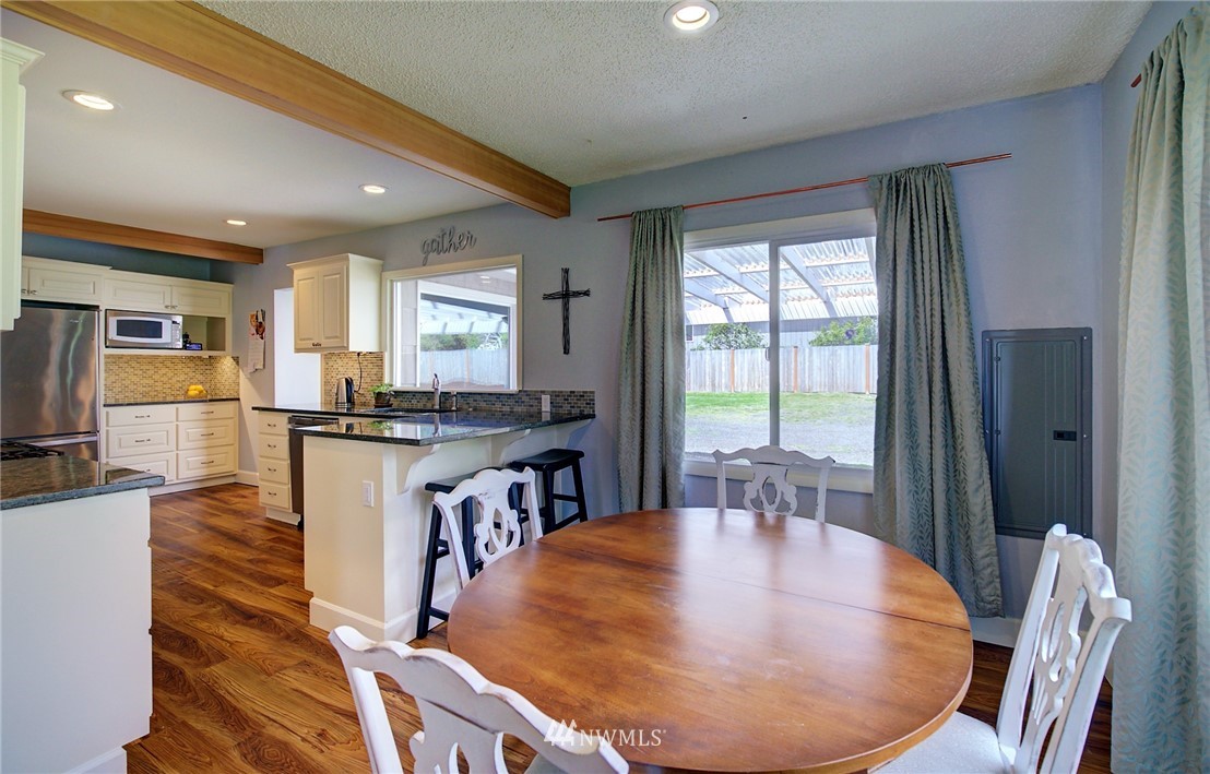 24316 Meridian Avenue South Bothell, WA 98021 - Photo 11 of 29 a view of a dining room with furniture window and wooden floor