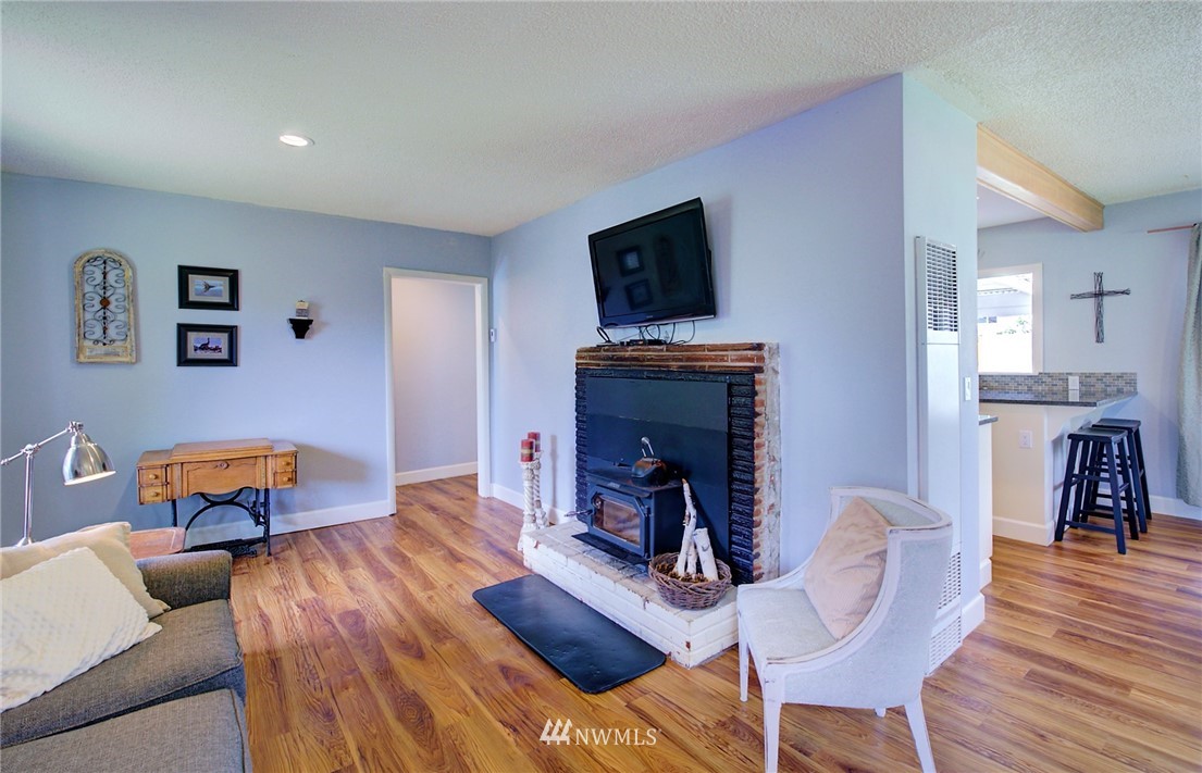 24316 Meridian Avenue South Bothell, WA 98021 - Photo 15 of 29 a living room with furniture and a fireplace