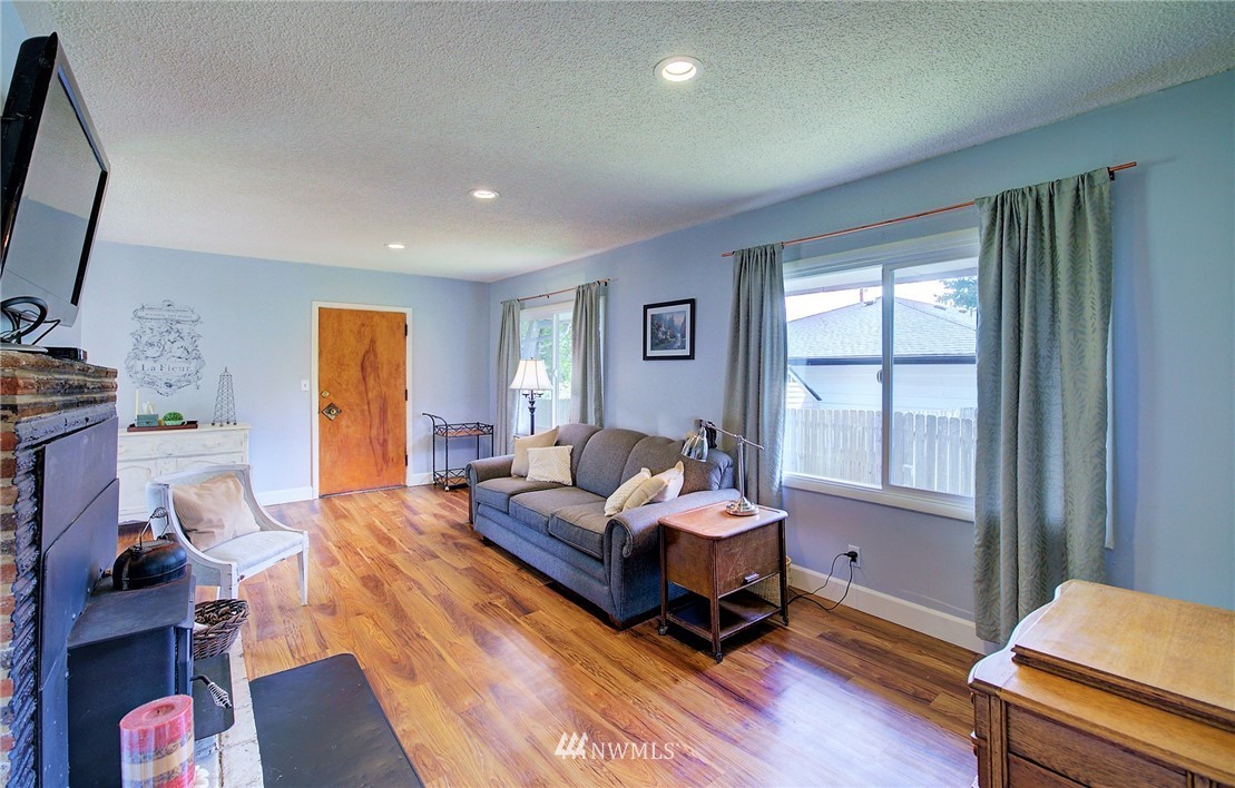 24316 Meridian Avenue South Bothell, WA 98021 - Photo 16 of 29 a bedroom with a bed and wooden floor