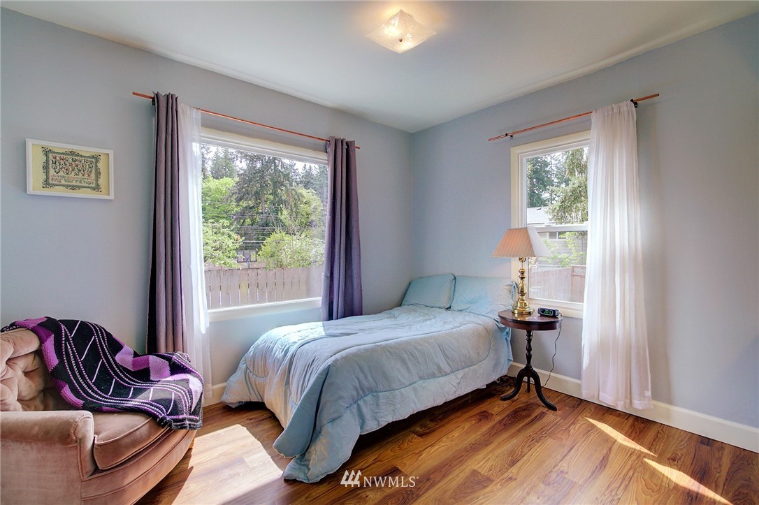 24316 Meridian Avenue South Bothell, WA 98021 - Photo 18 of 29 a bedroom with a bed and wooden floor