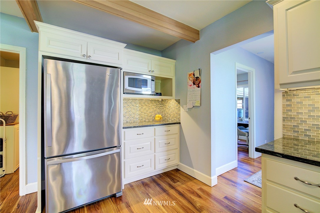 24316 Meridian Avenue South Bothell, WA 98021 - Photo 5 of 29 a kitchen with stainless steel appliances granite countertop a refrigerator and a stove top oven