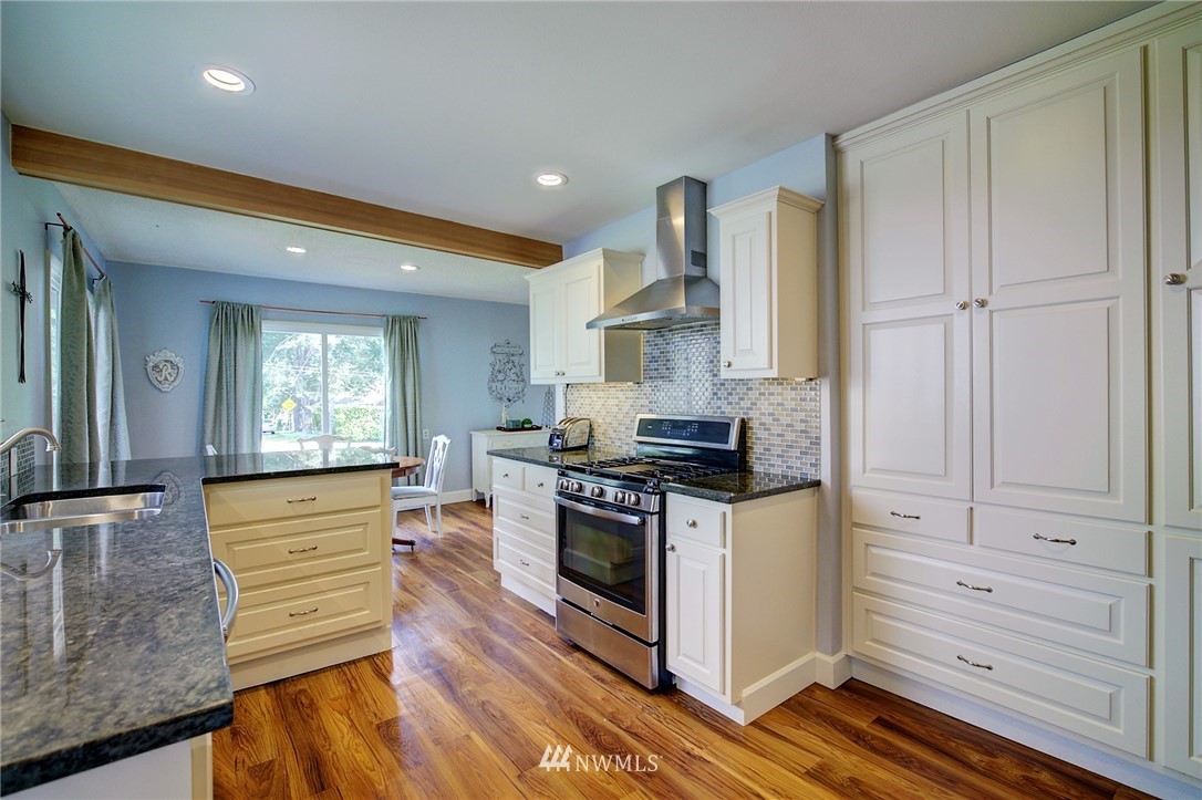 24316 Meridian Avenue South Bothell, WA 98021 - Photo 6 of 29 a kitchen with stainless steel appliances granite countertop a stove and a refrigerator