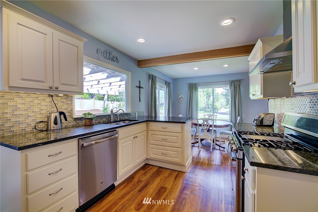 24316 Meridian Avenue South Bothell, WA 98021 - Photo 8 of 29 a kitchen with a sink stove and cabinets