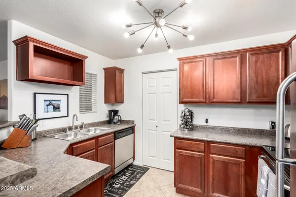 a kitchen with stainless steel appliances granite countertop a sink stove and microwave