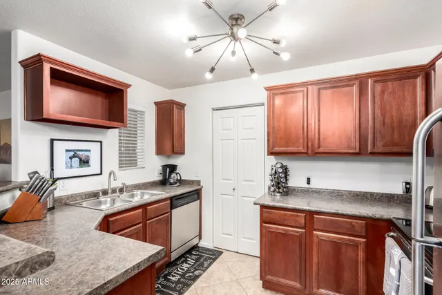 a kitchen with stainless steel appliances granite countertop a sink stove and microwave