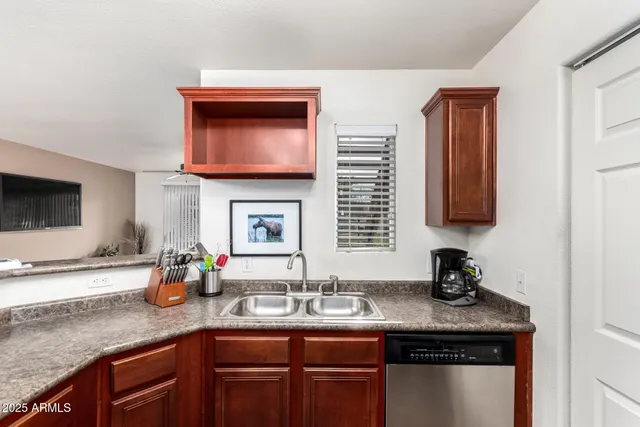 a kitchen with stainless steel appliances granite countertop a sink and cabinets