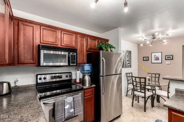 a kitchen with stainless steel appliances granite countertop a refrigerator stove and microwave