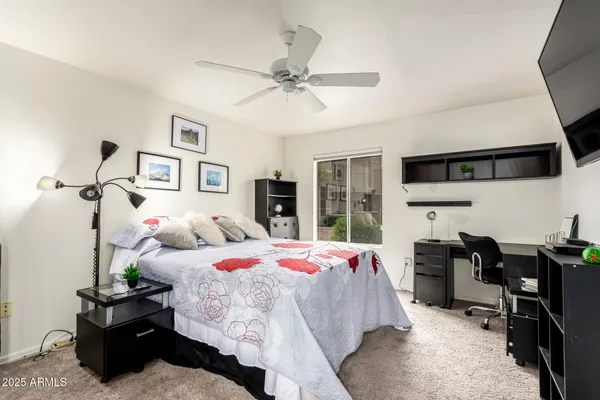 a bedroom with a bed and a chandelier