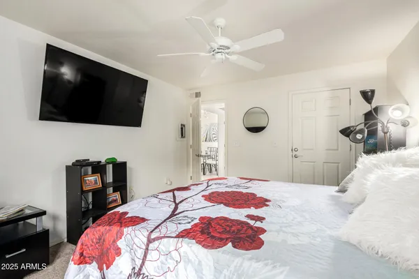 a bedroom with a large bed and a flat screen tv