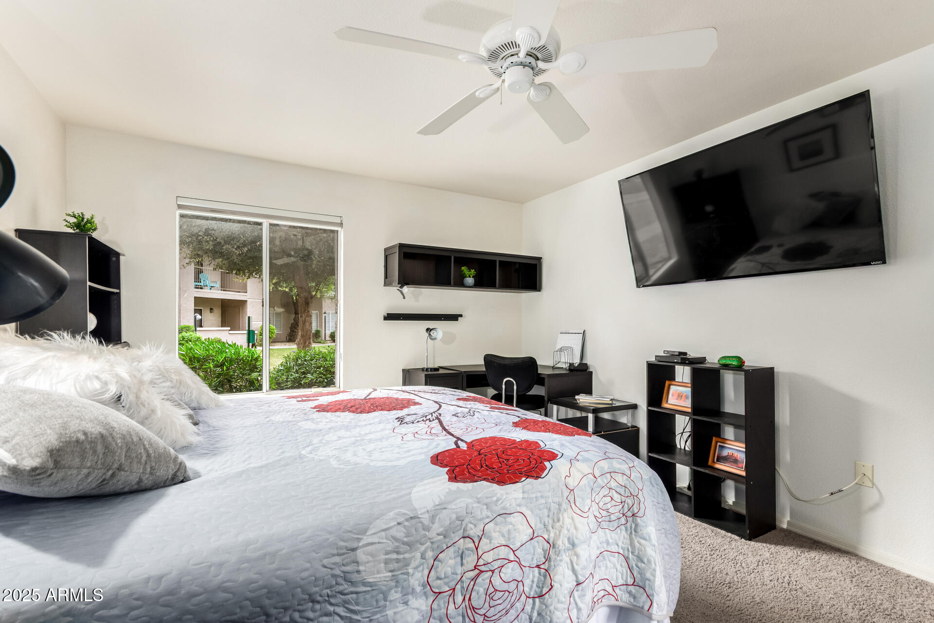 17017 North 12th Street, Unit 1123 Phoenix, AZ 85022 - Photo 17 of 48 a bedroom with a bed a flat screen tv and a fireplace