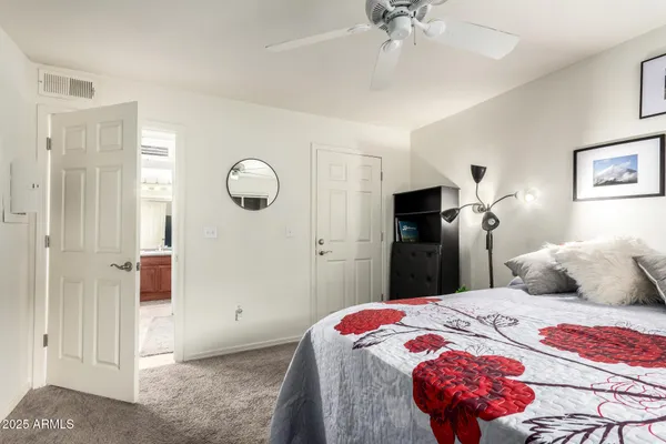 a bedroom with a bed and a chandelier
