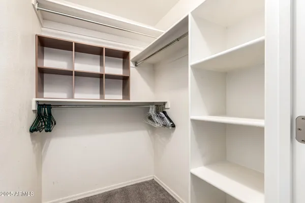 a view of walk in closet with empty racks