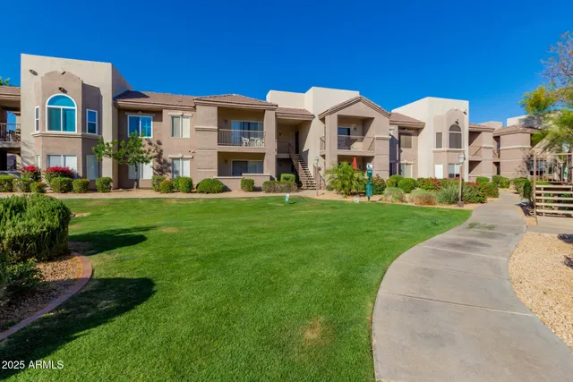 a front view of multiple houses with yard