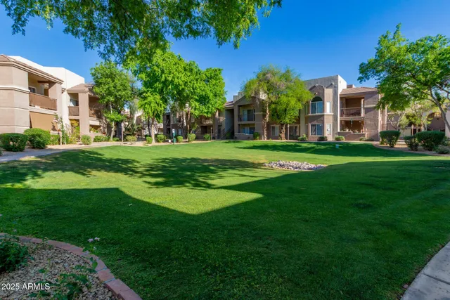 a front view of a building with a garden