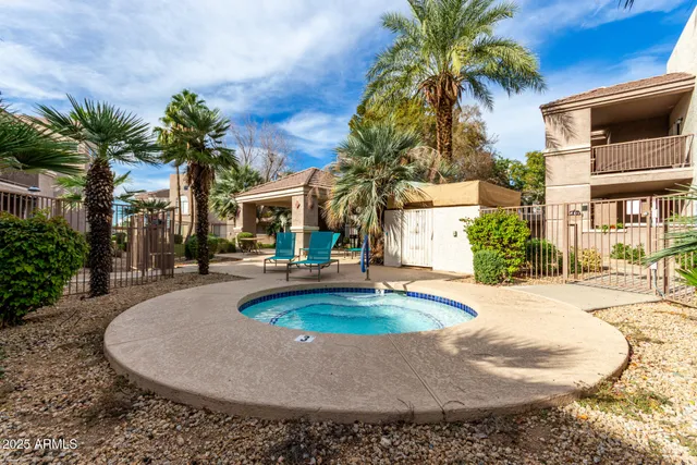 a view of a house with a swimming pool and sitting area