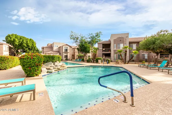 a view of a house with swimming pool and sitting area