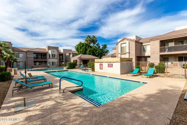 a view of a swimming pool with a lounge chairs