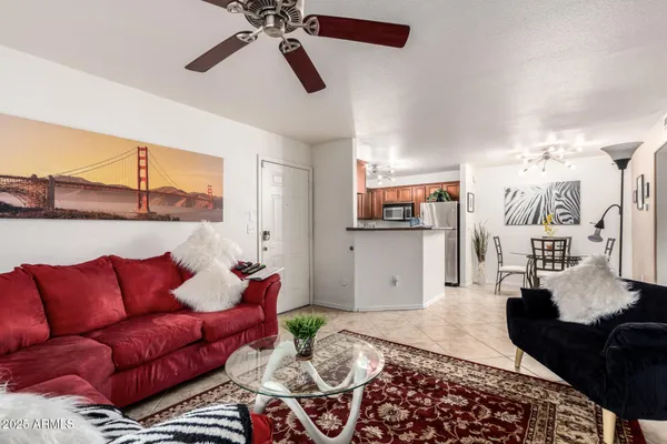 a living room with furniture and kitchen view