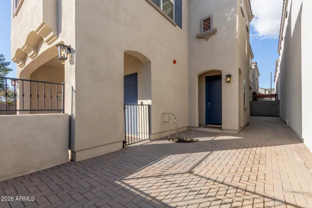 a living room with furniture a chandelier and a potted plant