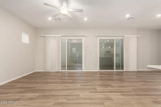 a kitchen with stainless steel appliances kitchen island hardwood floor sink and stove