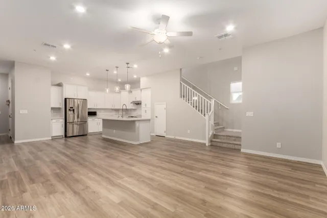 a kitchen with kitchen island a refrigerator a stove a sink and a center island