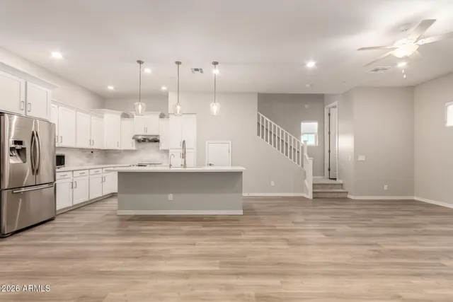 a kitchen with a sink and wooden floor