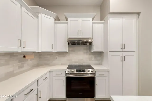 an empty room with a window and a ceiling fan