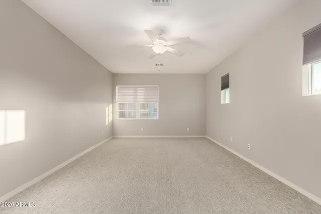 an empty room with windows and closet