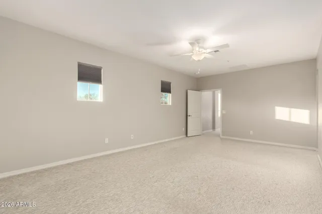 an empty room with a ceiling fan and closet