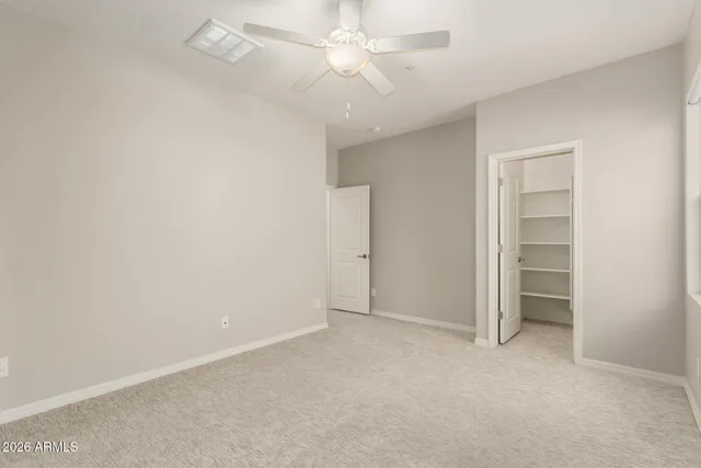 a living room with a couch and a potted plant on it