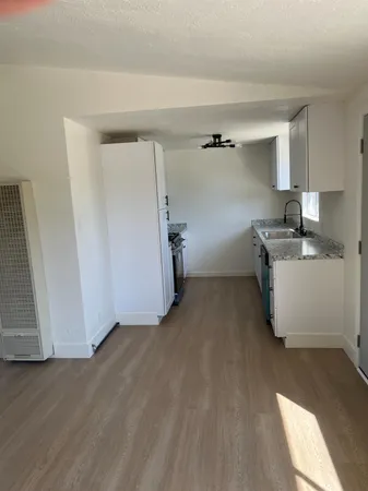 a view of a kitchen with a sink dishwasher and a fireplace